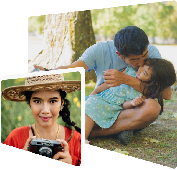 A man kissing his daughter on his lap, and a smiling girl holding a camera.